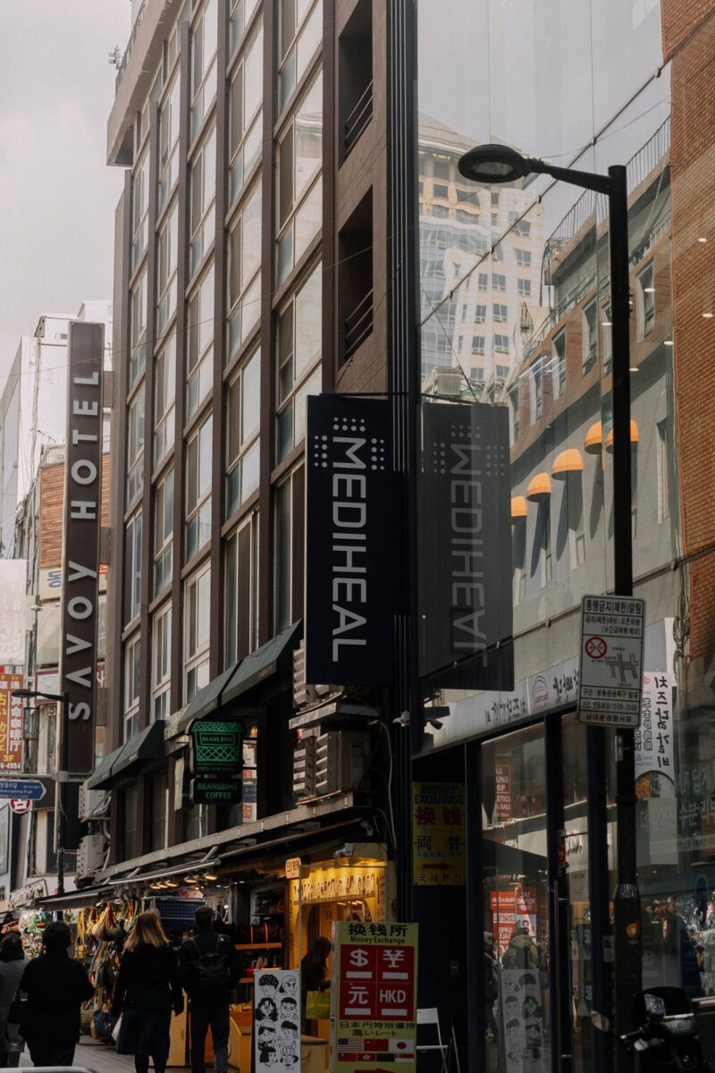 Street scene with shopping and signage in central Seoul, capturing urban life.